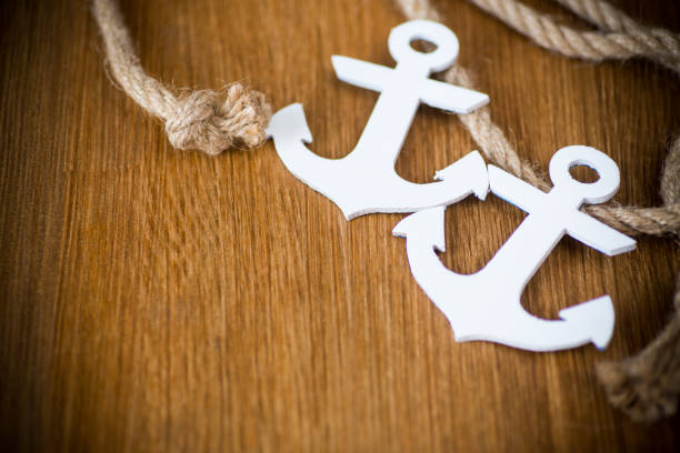 istock white decorative anchor on a wooden background 1092171756