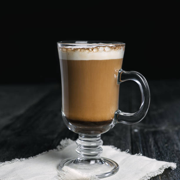 istock Irish coffee glass with foam and cinnamon on wooden table 1092171834