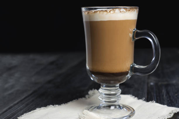 istock Irish coffee glass with foam and cinnamon on wooden table 1092171852