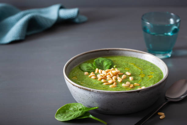 istock green creamy cauliflower spinach soup on gray background 1092173394
