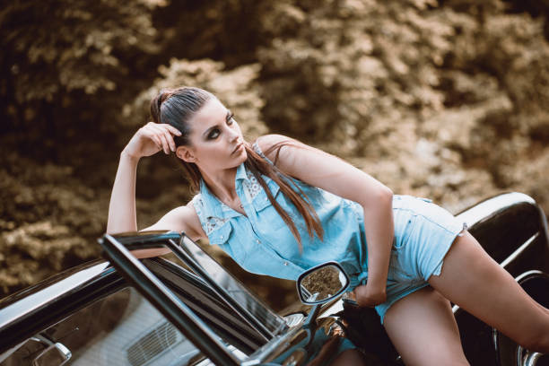 istock Adorable Female Posing While Leaning On Vintage Car 1092173894