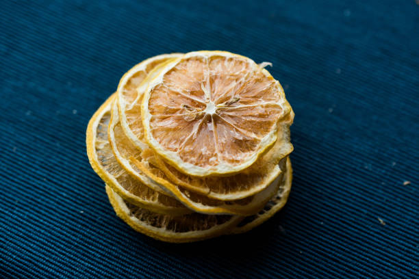 istock Stack of Dried Lemon Slices on Blue Surface / Dry and Sliced 1092174656