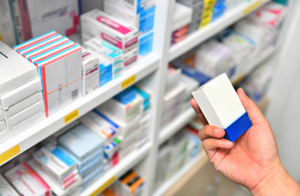 istock Pharmacist hand holding medicine box in pharmacy store 1092177446