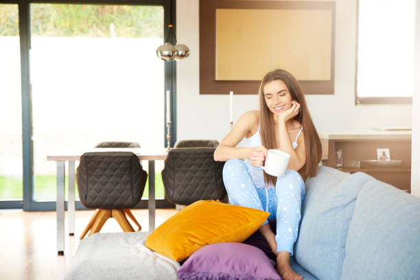 istock Young woman relaxing on sofa early morning 1092179056