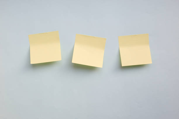 istock Three yellow paper stickers note with copy space on blue background 1092181374