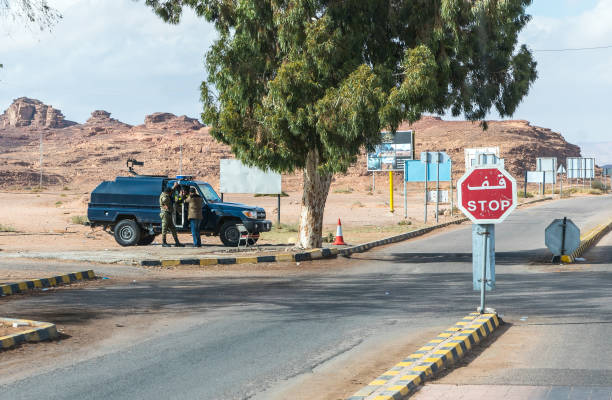 jordanian military police guard the entrance to the wadi rum desert near aqaba city in jordan - travel jordan israel sand imagens e fotografias de stock