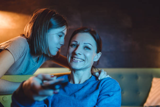 istock Mother watching TV while daughter saying good night 1092185188