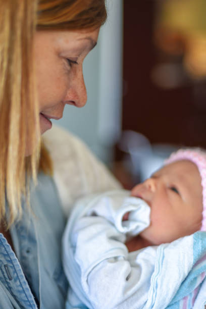 istock Woman holding newborn 1092185230
