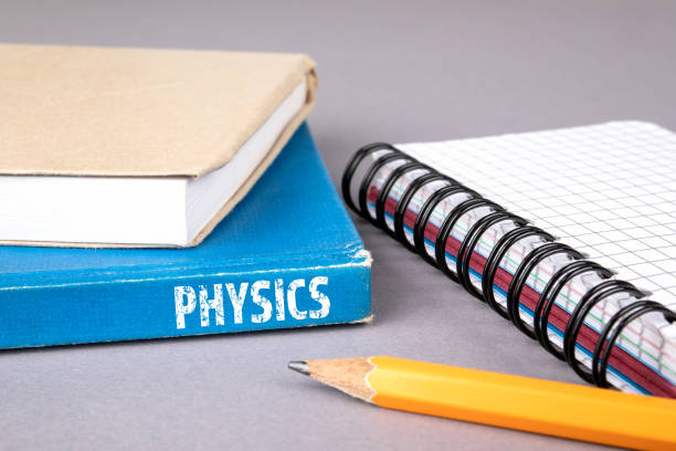 physics concept. blue book on a gray office table - neutrino imagens e fotografias de stock