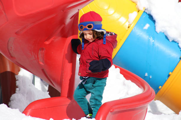 istock Boy playing with snow in the park in winter day. 1092186954