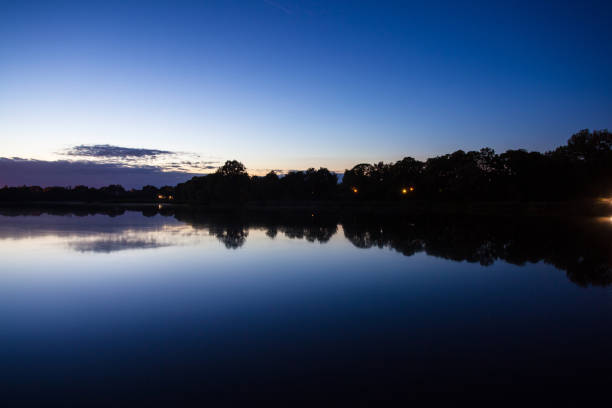istock forest by the lake at dusk, long exposure 1092187190