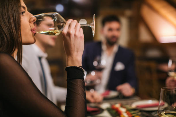 istock Beautiful woman drinking white wine at lunch 1092188380