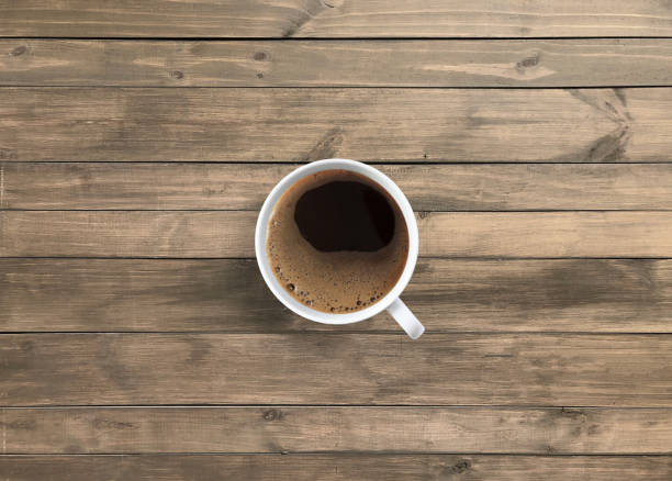 istock Hot americano black coffee in white mug on wooden table 1092188716