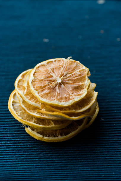 istock Stack of Dried Lemon Slices on Blue Surface / Dry and Sliced 1092190668
