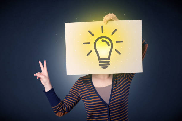 istock Woman holding paper with lightbulb 1092193458
