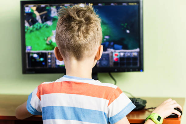istock boy playing computer game behind the monitor 1092196552