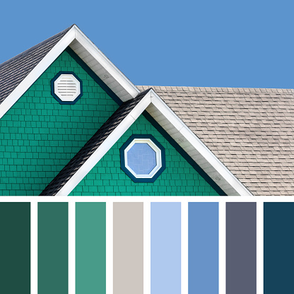 The colour houses of the Magdalen Islands in Canada, with a blue sky background, In a colour palette with complimentary colour swatches.