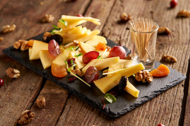 Appetizer Plate full of cheese slice on old wooden table edam stock pictures, royalty-free photos & images