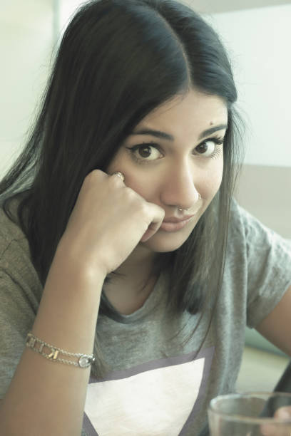 istock Bored girl looking intently at camera. 1092208048