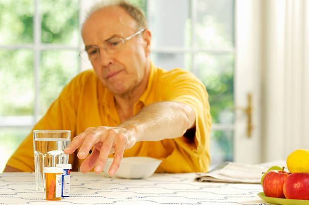 istock Elderly man reaching for his medications. 109221073