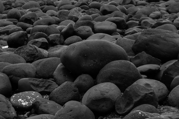 istock Big smooth black beach stones background 1092216288