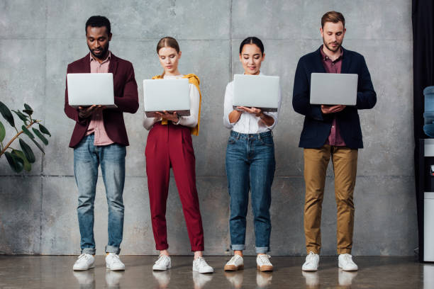 istock concentrated multiethnic casual businesspeople using laptops in waiting hall 1092216880