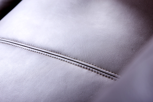 Closeup of a brown leather cushioned sofa