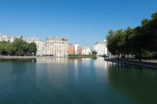 La Villette basin on Canal Saint-Martin, Paris Paris/France - August 16 2016: The Canal Saint-Martin is a 4.5 km long canal in Paris. It connects the Canal de l'Ourcq to the river Seine st. martins stock pictures, royalty-free photos & images