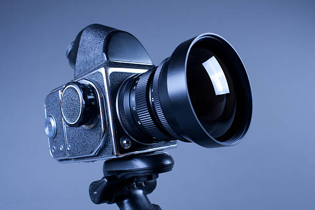 istock Old photo camera with tripod on grey in Hi-Res 109223616