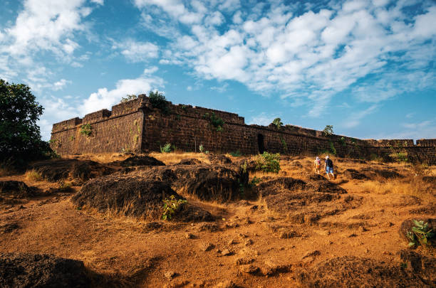 Ruins of Chapora fort, North Goa, India Arambol, Goa, India - December 08, 2014: Tourists go to the ruins of Chapora fort, located near Vagator village, North Goa, India chapora fort stock pictures, royalty-free photos & images
