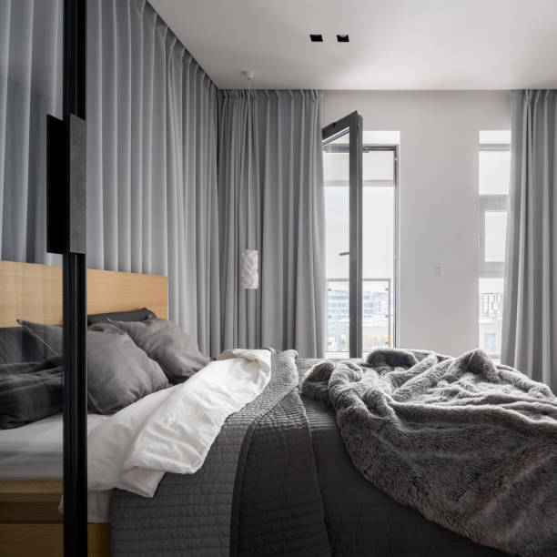 istock Luxurious bedroom with gray window curtains 1092239484