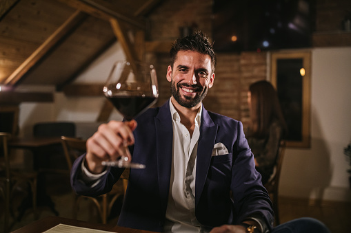 Portrait of handsome businessman man in winery, looking at camera