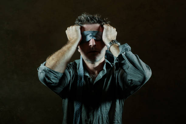 istock young lost and confused man blindfolded with necktie playing internet trend dangerous viral challenge with eyes blind acting doubtful guided by intuition isolated on dark background 1092242834