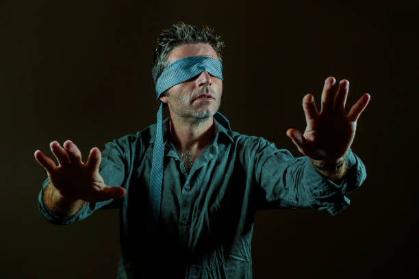 istock young lost and confused man blindfolded with necktie playing internet trend dangerous viral challenge with eyes blind acting doubtful guided by intuition isolated on dark background 1092242838