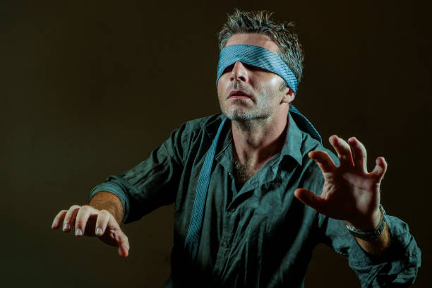 istock young lost and confused man blindfolded with necktie playing internet trend dangerous viral challenge with eyes blind acting doubtful guided by intuition isolated on dark background 1092243024