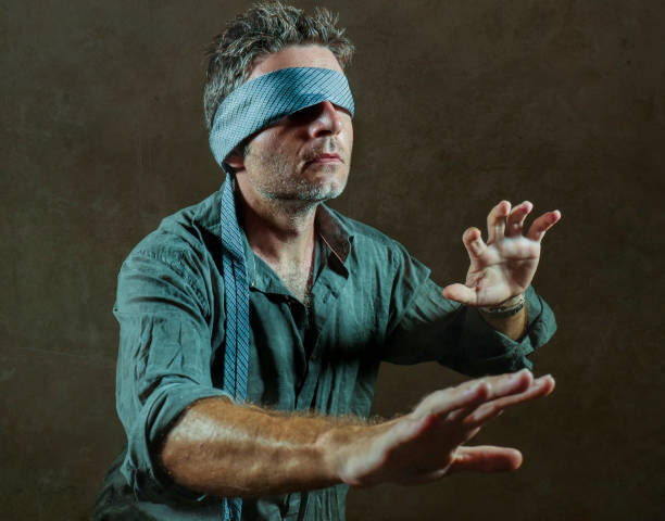 istock young lost and confused man blindfolded with necktie playing internet trend dangerous viral challenge with eyes blind acting doubtful guided by intuition isolated on dark background 1092243038