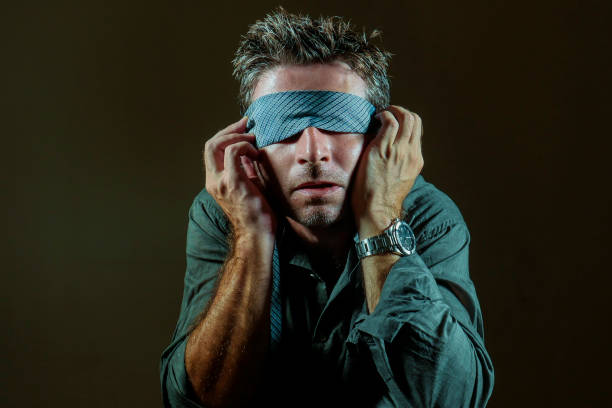 istock young lost and confused man blindfolded with necktie playing internet trend dangerous viral challenge with eyes blind acting doubtful guided by intuition isolated on dark background 1092243082