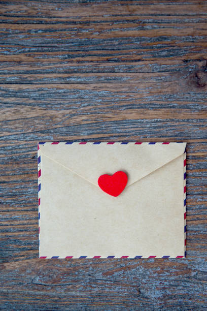 istock Craft envelope with red heart on the wooden textured background. 1092243832