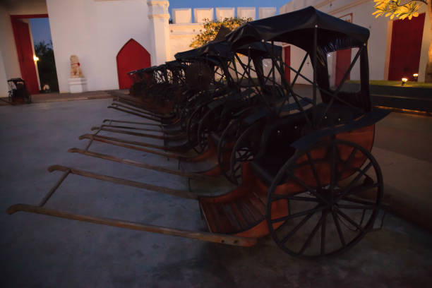 istock Transportation, Asian Thai Traditional man drawn vintage carriages or pulled rickshaws (ricksha, jinriksha), mode of human-powered transport by which a runner draws two-wheeled cart which seats people 1092252194