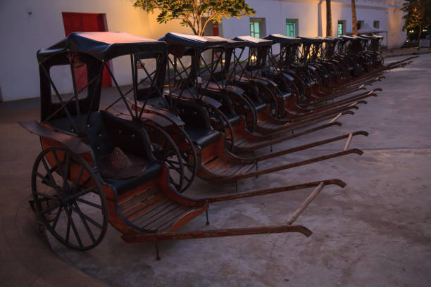 Transportation, Asian Thai Traditional man drawn vintage carriages or pulled rickshaws (ricksha, jinriksha), mode of human-powered transport by which a runner draws two-wheeled cart which seats people