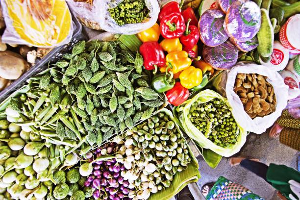 istock People walking by various vegetables on fresh market stall. 1092256414
