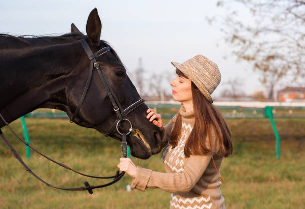 istock Woman and  horse, beige pullover, close up 1092257488
