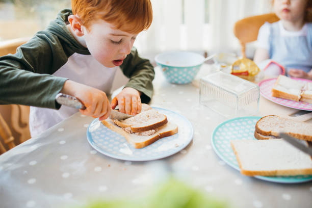 istock Young Boy Making His Sandwiches for Lunch 1092261654