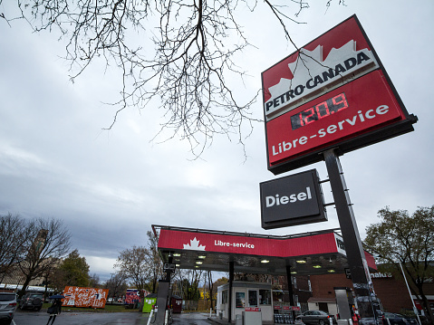 Picture of a sign with the logo of Petro Canada taken in front of a petrol station in Quebec, in Montreal, Canada. Petro-Canada is a retail and wholesale marketing brand of Suncor Energy, selling petroleum accross canada in their gas stations.