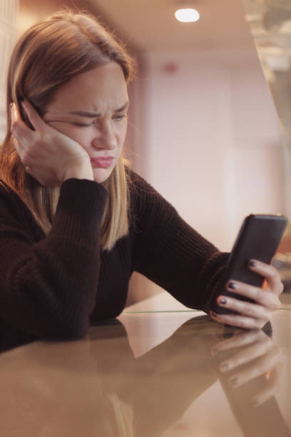 istock Young girl playing game on her mobile phone 1092262932