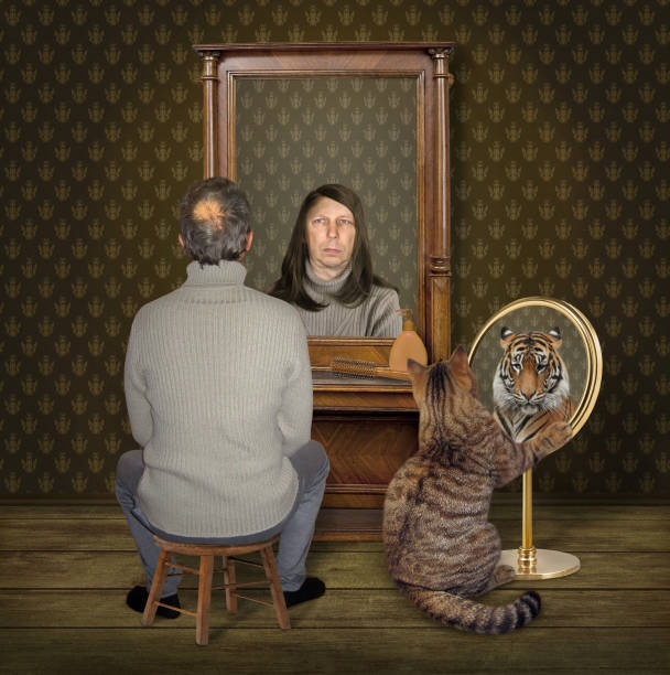 istock Cat and man look at their reflections 1092267440