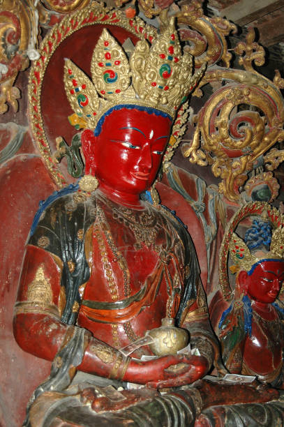 istock Ancient sacred Buddha statue with a red face in a crown in a Tibetan monastery 1092274172