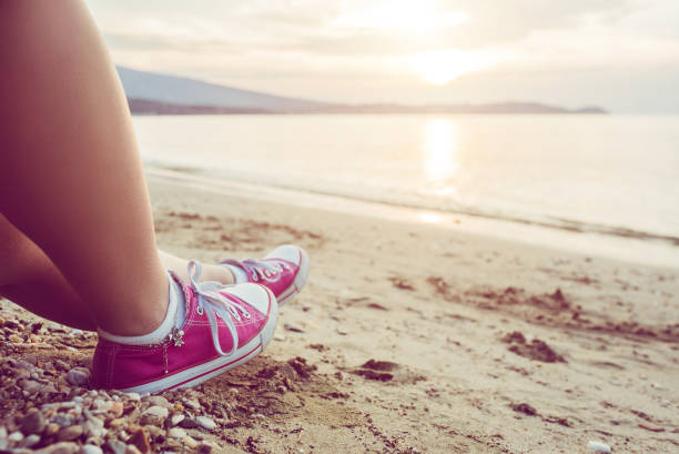 istock Female legs sunbathing on the beach 1092274408