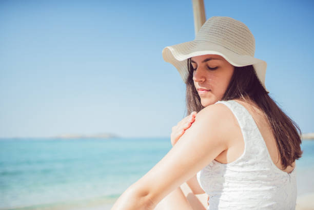istock Young woman sunbathing on the beach 1092275808