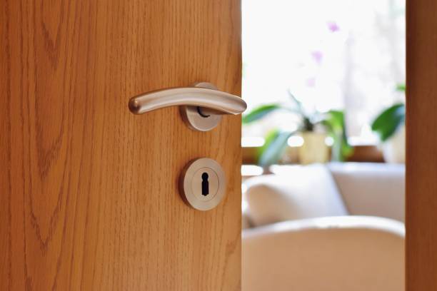 Half opened door into the cozy home interior Home sweet home scene doorknob photos stock pictures, royalty-free photos & images